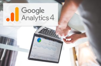 A user looking at Google Analytics but the image is upside down. GA4 has turned the world of analytics upside down.