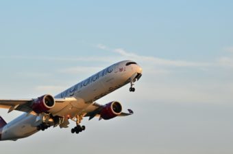 A photo of a Virgin Atlantic plane soaring through the sky.