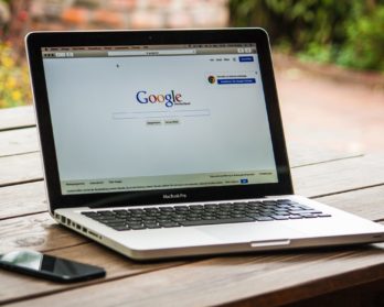 Photo of a laptop with Google's homepage on the screen. It is German Google.