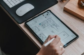 Photo of a tablet with a technical drawing on the screen with someone using a tablet pen to draw with.