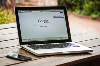 Photo of a laptop with Google's homepage on the screen. It is German Google.