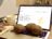 An open laptop with 3 potatoes on the keyboard and Google Analytics displayed on the screen.